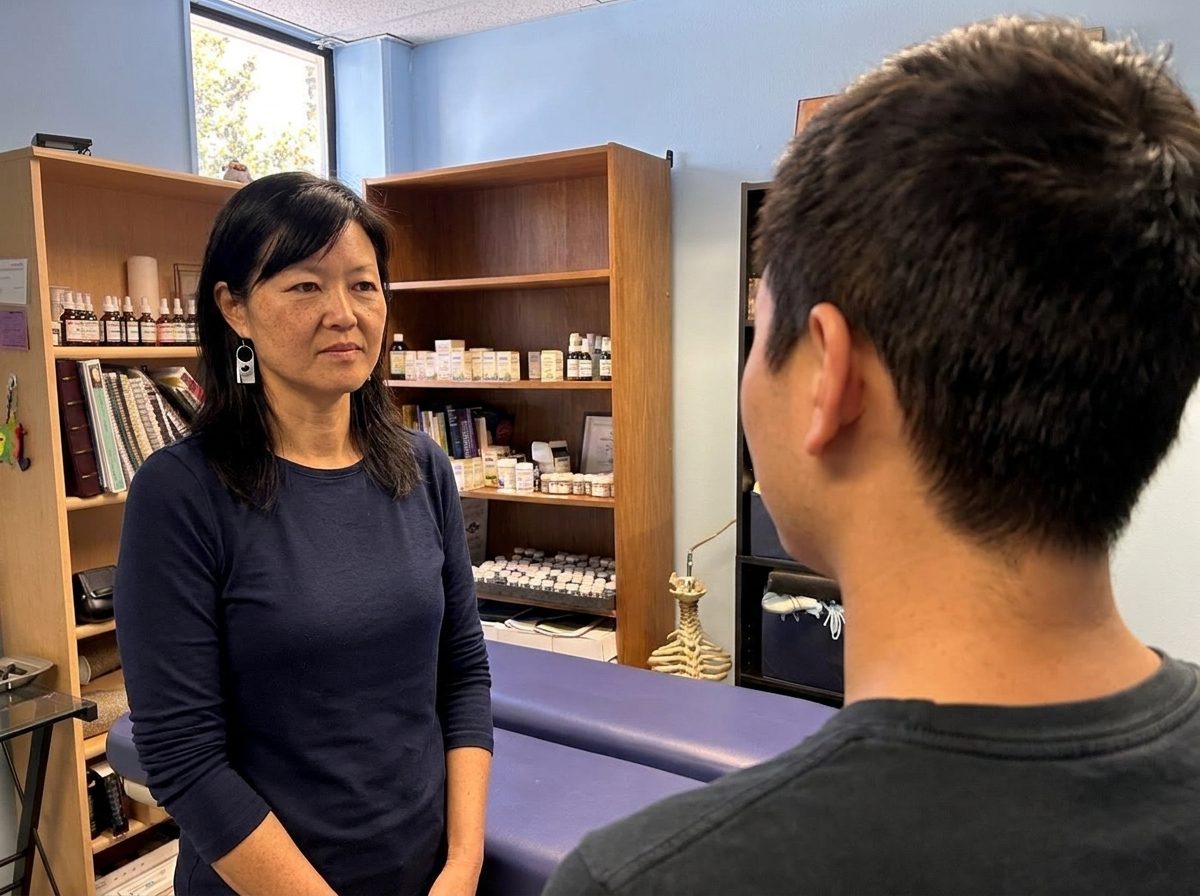 The retest: a person turns their head while Dr. Bae watches, seen from behind the person at shoulder level
